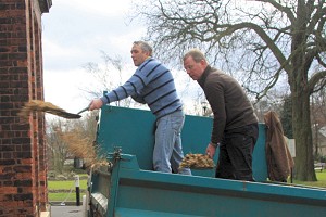 John and Patrick mulch some beds